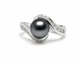 a black pearl and diamond ring on a white background