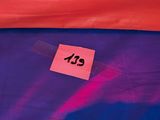 a red and blue tent with a sticker on it