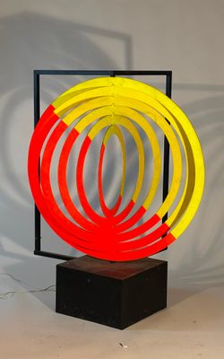 an image of a sculpture of a red, yellow, and blue ring