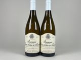 two bottles of wine sitting next to each other on a table