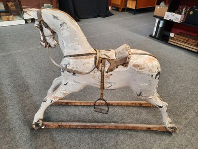 a wooden rocking horse that is sitting on the floor