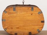a wooden suitcase sitting on a table with a metal handle