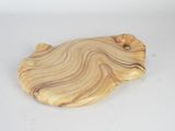 a wooden cutting board with a wavy design on it