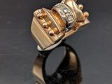 a close up of a gold ring with a diamond on top of it