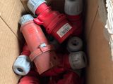 a cardboard box full of red and white electrical plugs