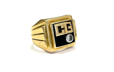 an image of a gold ring with a black and white logo on it