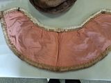 a hat that is sitting on a table next to a piece of cloth