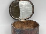 an old silver box with a mirror on top of it