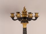 a black and gold candelier with five candles on it