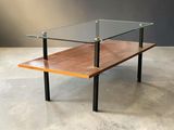 an image of a glass and wood coffee table on a concrete floor