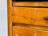 a wooden dresser with three drawers on it