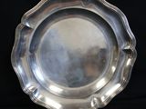 silver plate with scalloped edge on a black background