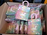 a cardboard box full of bags with unicorns on them