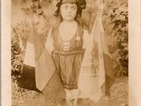 une vieille photo d'une petite fille tenant un drapeau