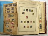 an open book with stamps inside of it on a table