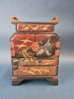 an image of a wooden chest of drawers with birds and flowers painted on it
