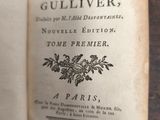 an old book open on a table with a black and white picture