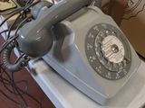 a white plate with a telephone on it and a stack of plates