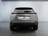 the rear end of a silver suv parked in a garage