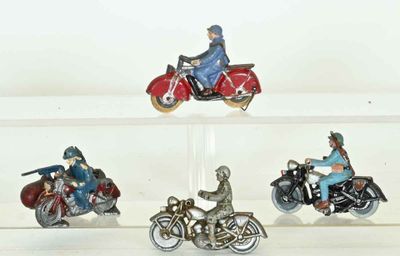 four miniature figurines of people riding motorcycles on display