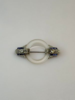 a white ring with blue and white stones on it