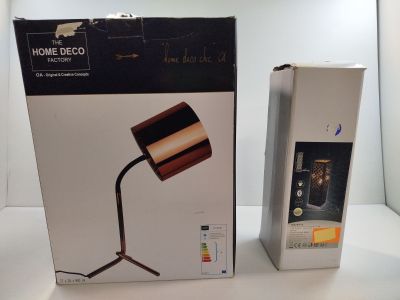 packaging for a lamp that is sitting on a table next to a box