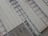 many ladders that are leaning against the wall