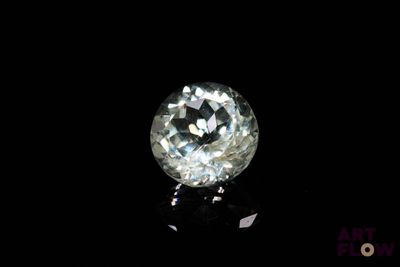 a close up of a white diamond on a black surface