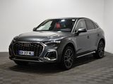 a grey audi suv parked in a room with a checkered floor