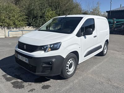 the white van is parked in a parking lot with trees in the background