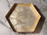 a soap dish that is sitting on a marble table