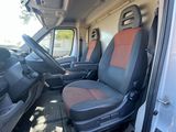 the interior of a van with two seats and a steering wheel