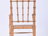 a wooden chair with a woven seat on a white background
