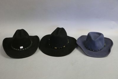three hats are lined up in a row on a white surface