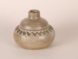 a small vase that is sitting on a white surface