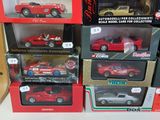 a lot of different model cars in boxes on the table