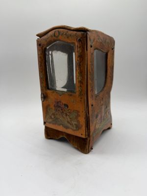 a small wooden clock that is on a white surface