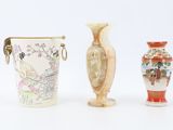three vases sitting next to each other on a white surface