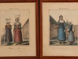 two framed pictures of women in traditional clothing standing next to each other