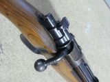a close up of a rifle with a wooden handle