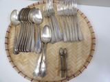 a lot of silver spoons and spoons on a plate