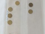 a lot of coins in a plastic bag on a table