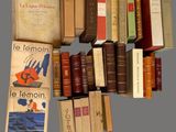 many books that are stacked on top of each other