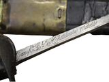 a close up of a knife and a bottle of wine