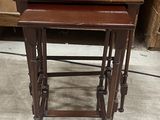 three wooden nesting tables sitting on top of a floor next to a dresser
