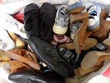 many pairs of shoes in a basket on the floor