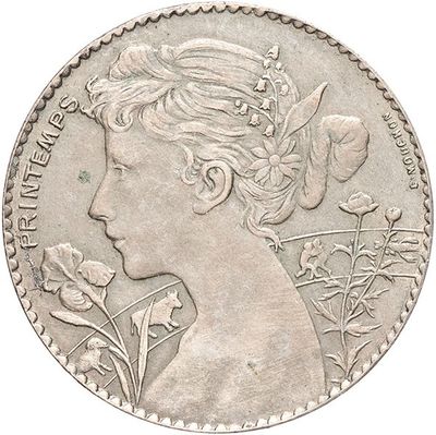l'image d'une pièce de monnaie sur laquelle figure le profil d'une femme