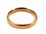 an image of a gold wedding ring on a white background