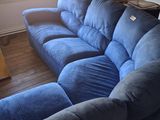 a blue couch in the corner of a living room