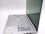 a silver laptop computer sitting on top of a white table